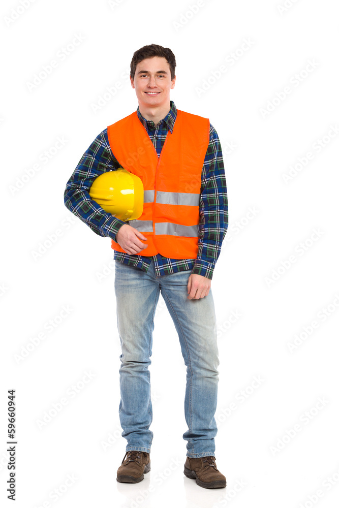 Smiling construction worker with helmet under the arm. Smiling construction worker with helmet under the arm.