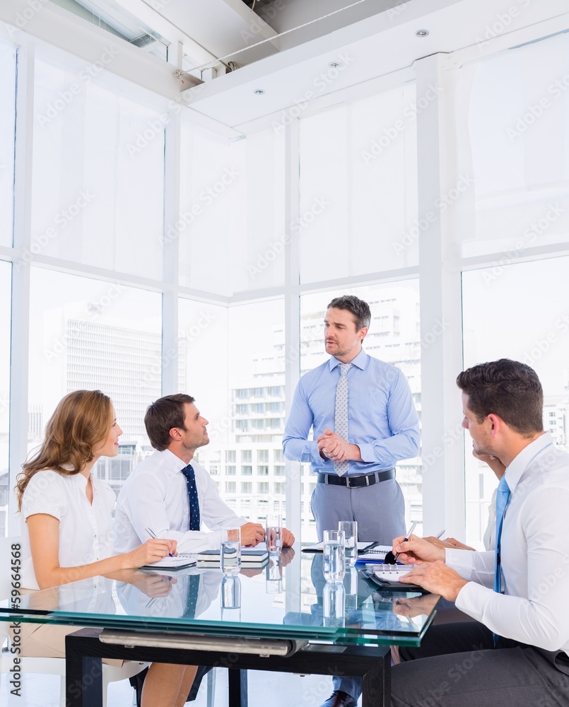Executives sitting around conference table Executives sitting around conference table