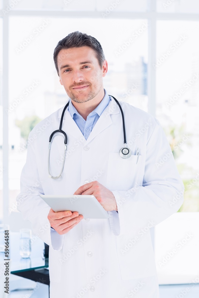 Portrait of a male doctor using digital tablet Portrait of a male doctor using digital tablet