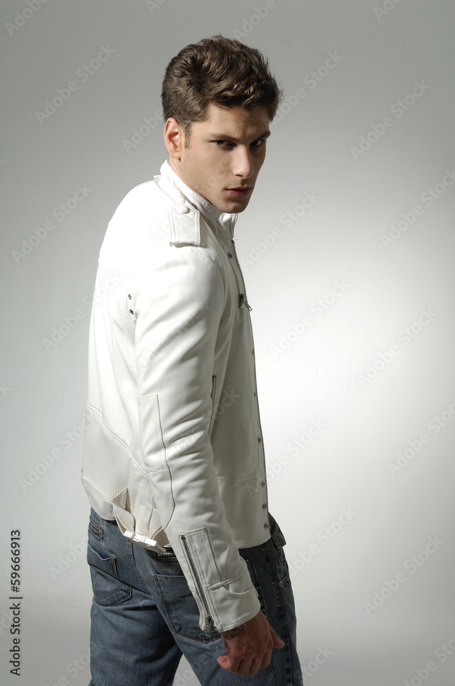 young man in white shirt looking over the shoulder on light young man in white shirt looking over the shoulder on light