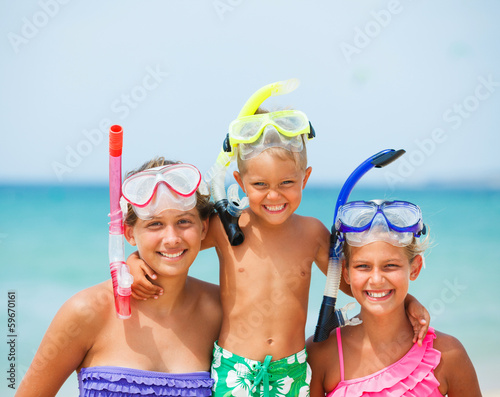 three happy children on beach...