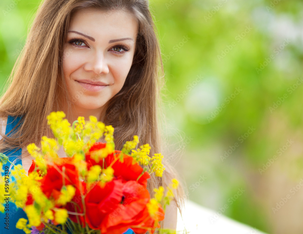Portrait of a cheerful woman outdoors with red poppy flowers Portrait of a cheerful woman outdoors with red poppy flowers
