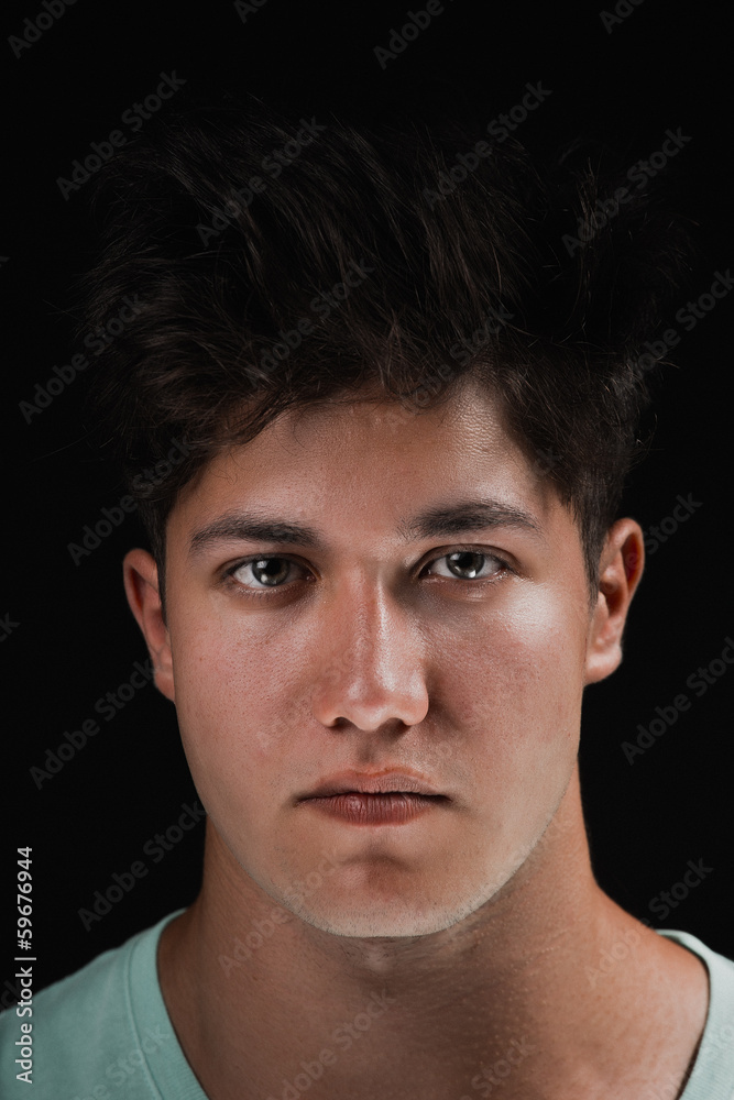 Close-up portrait of attractive young man on black background Close-up portrait of attractive young man on black background