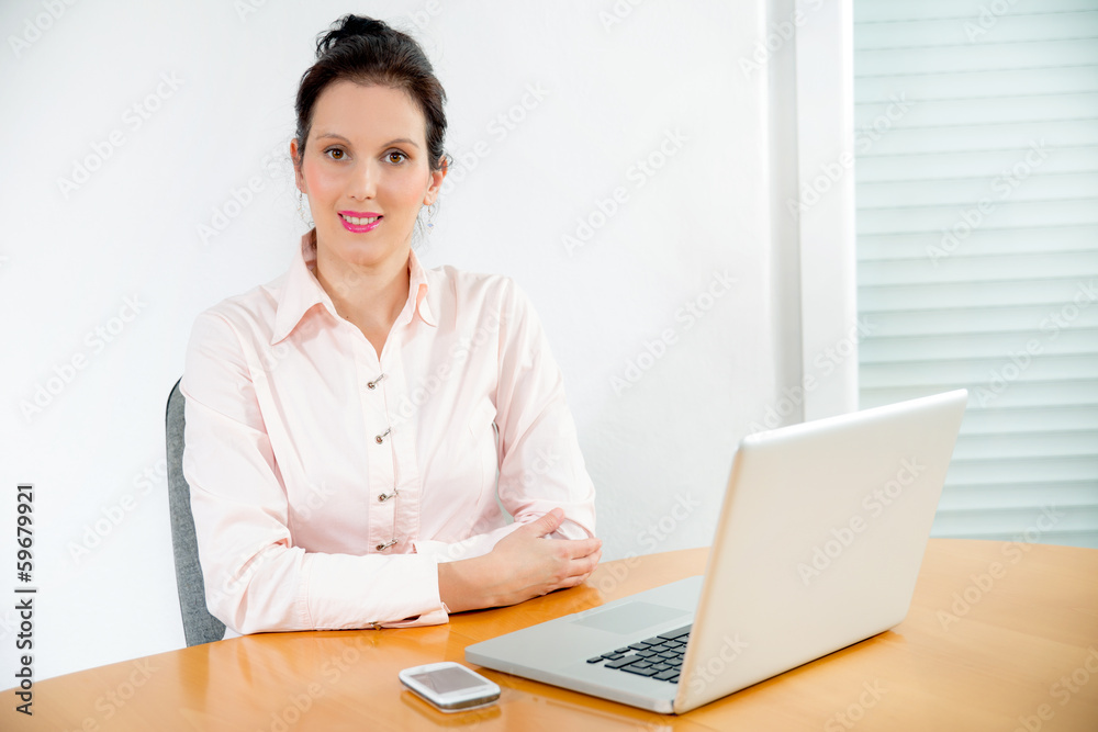 Portrait of an elegant businesswoman with laptop in a office Portrait of an elegant businesswoman with laptop in a office