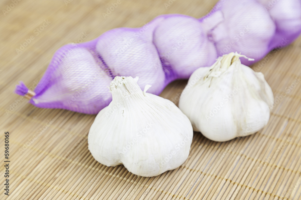 Raw garlic on bamboo Raw garlic on bamboo