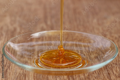 Dripping honey on a glass plate