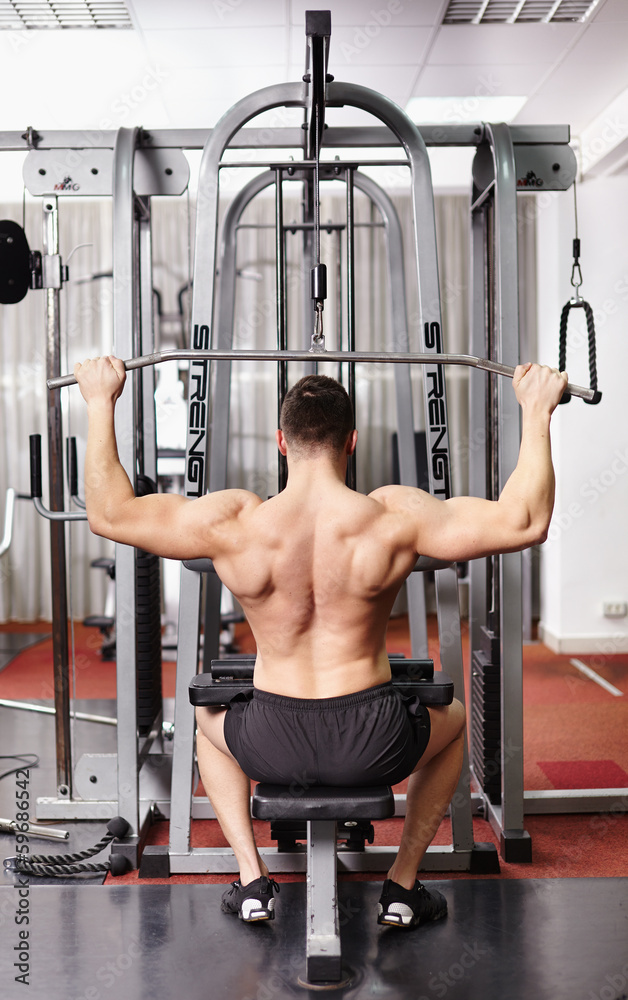 Fototapeta premium Athletic man pulling heavy weights