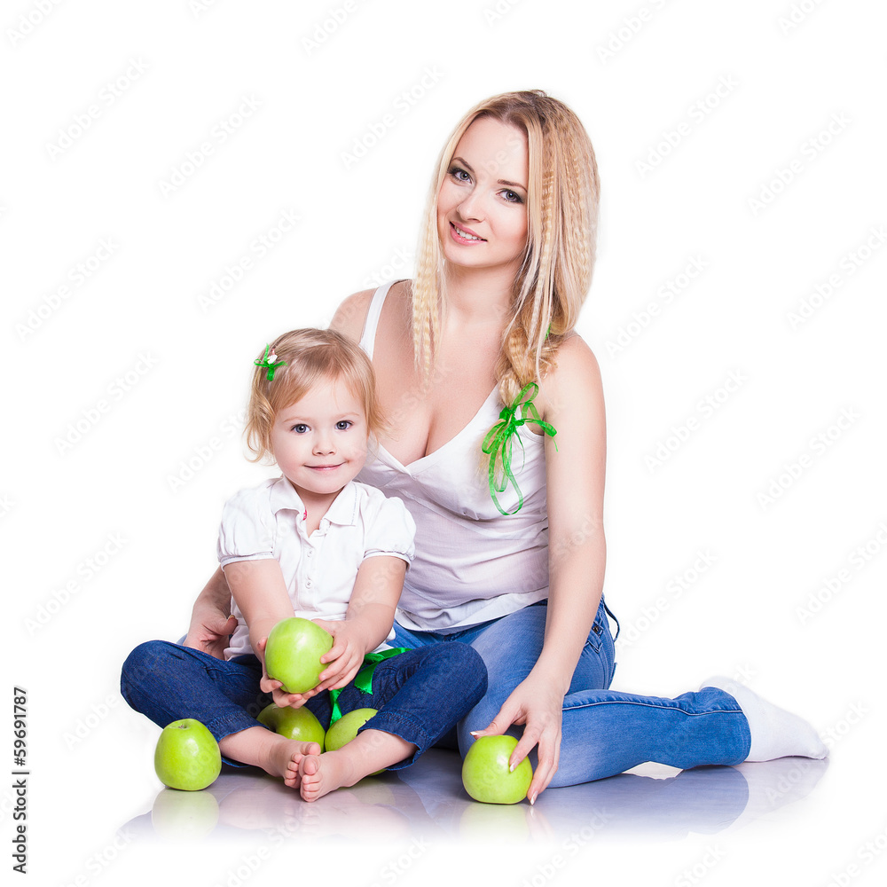 Fototapeta premium portrait of young mother and little daughter with apples