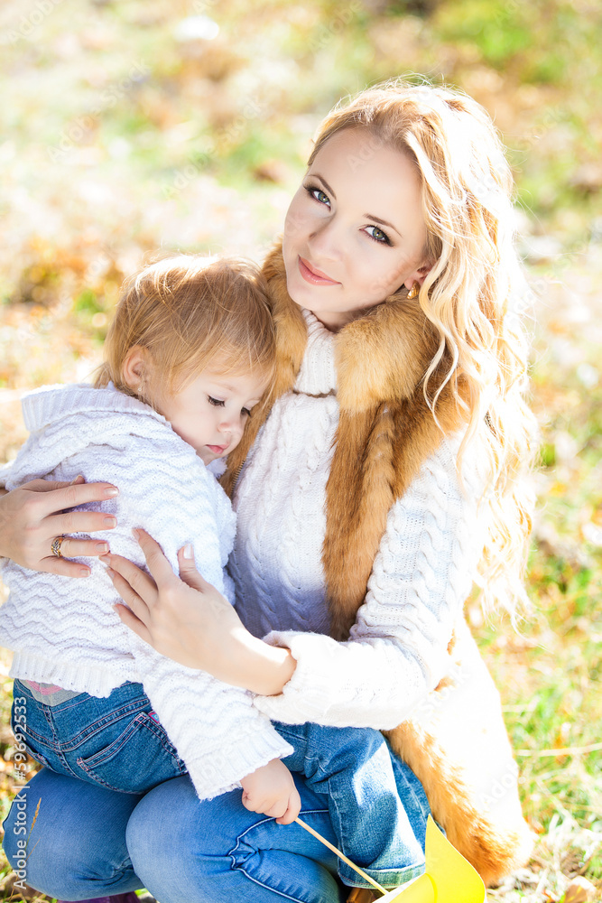Young mother playing with her daughter in autumn park Young mother playing with her daughter in autumn park