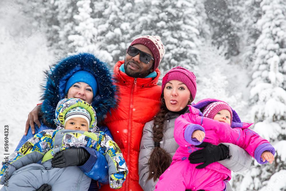 Happy Family with children in ski suit in snowy winter