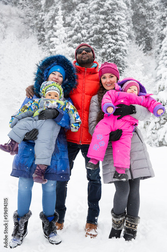 Happy Family with children in ski suit in snowy winter