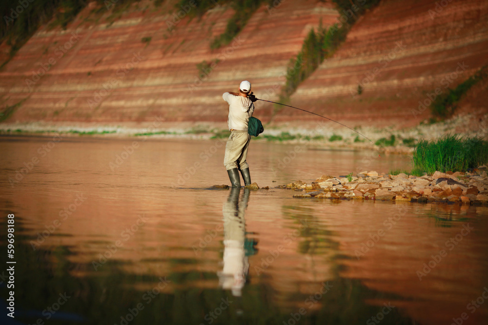 Naklejka premium young man on a fishing trip