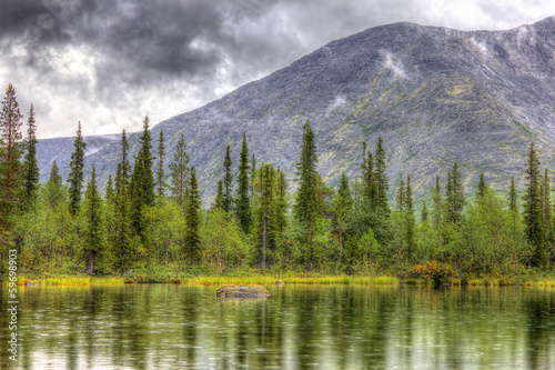 mountain landscape with lake, forest and clouds, rainy, hdr © Den