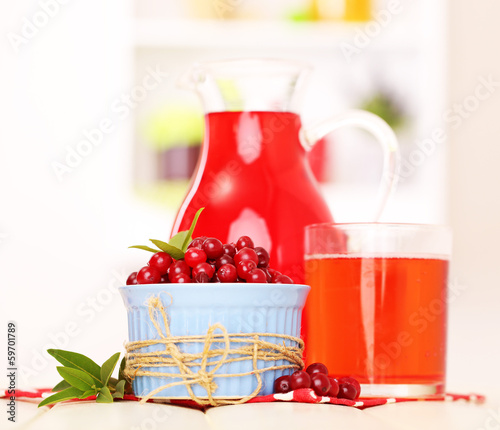 Pitcher and glass of cranberry juice with red cranberries