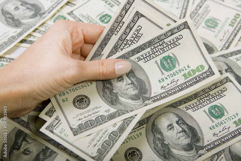 hand holding a lot of new hundred dollar hand holding a lot of new hundred dollar