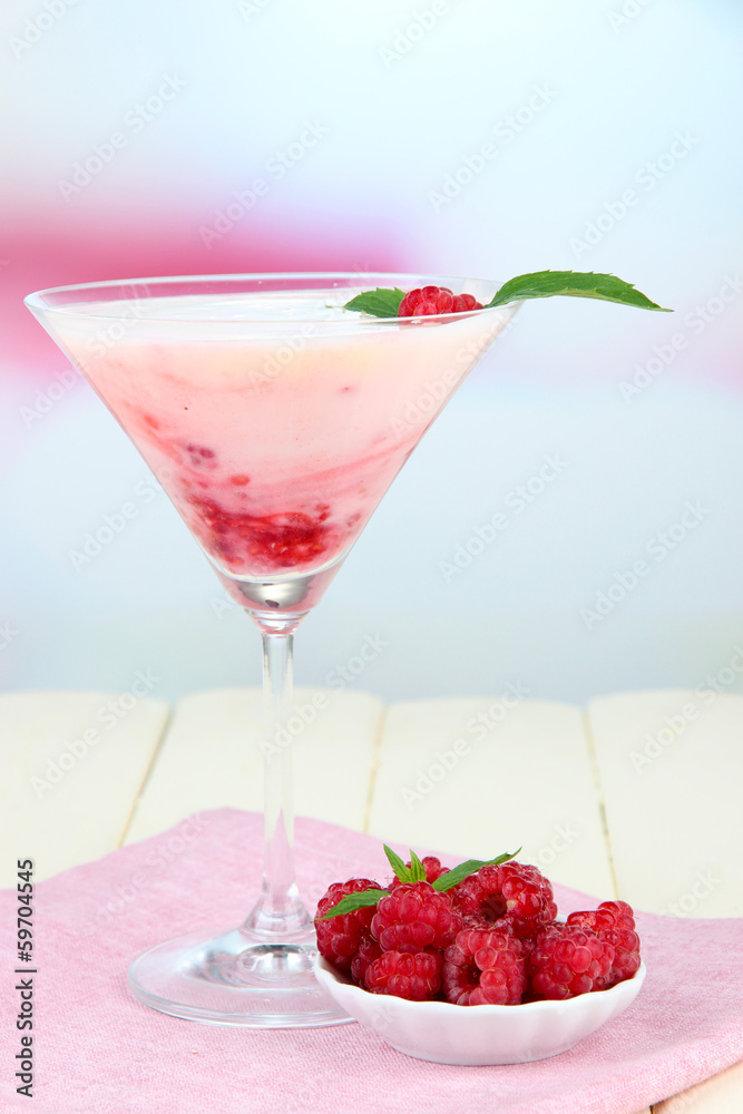 Raspberry milk dessert in cocktail glass, on light background Raspberry milk dessert in cocktail glass, on light background