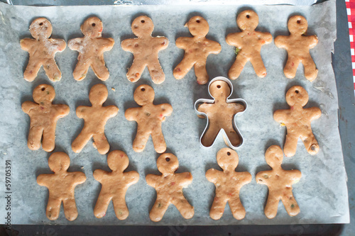 Raw gingerbread men on a baking