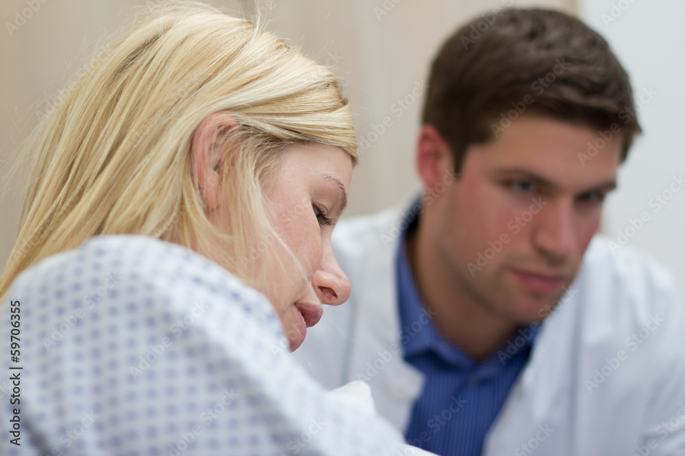 Fototapeta premium doctor talking with female patient in a hospital