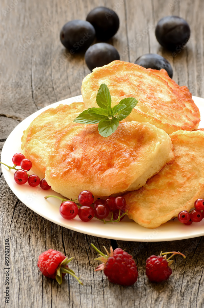 Pancakes decorated with red currant berries