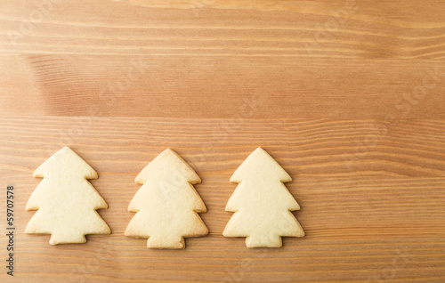 Christmas tree cookies over the wooden background