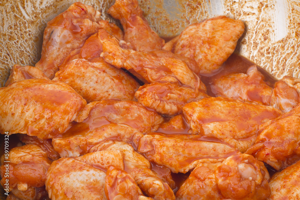 Raw chicken wings in spice prepare for cooking