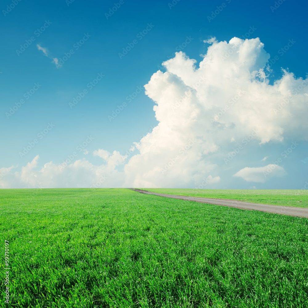 clouds in blue sky over green grass clouds in blue sky over green grass