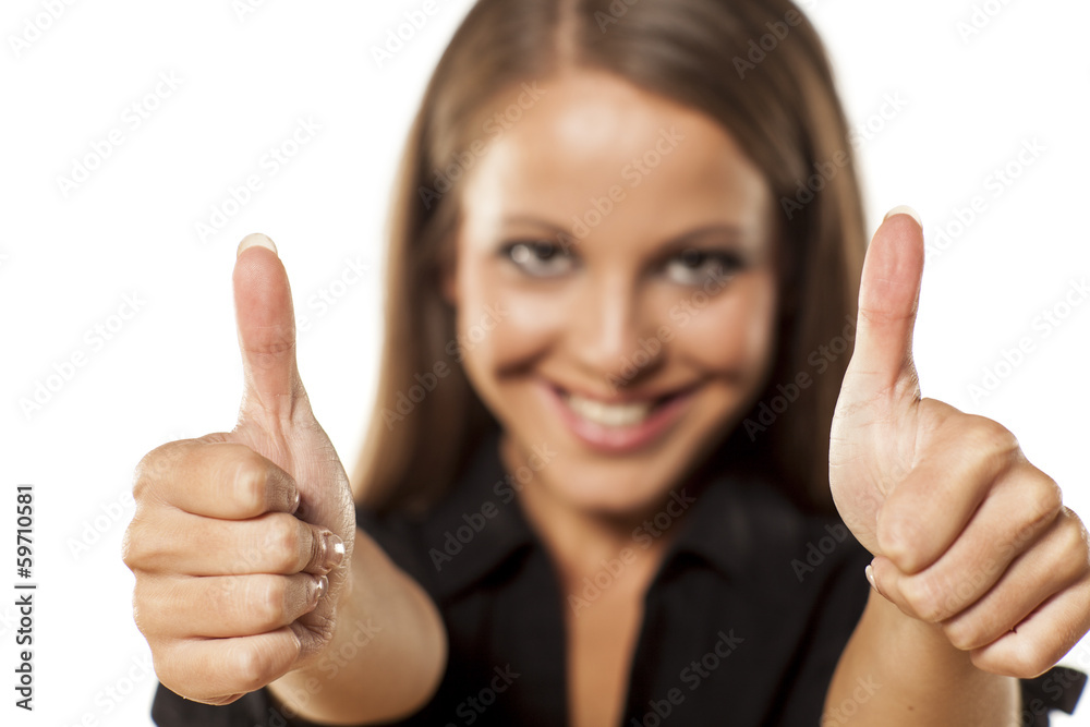 portrait of the smiling girl that shows the thumbs up portrait of the smiling girl that shows the thumbs up