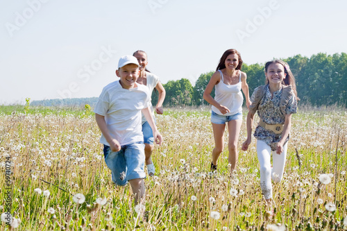 Friends running in meadow