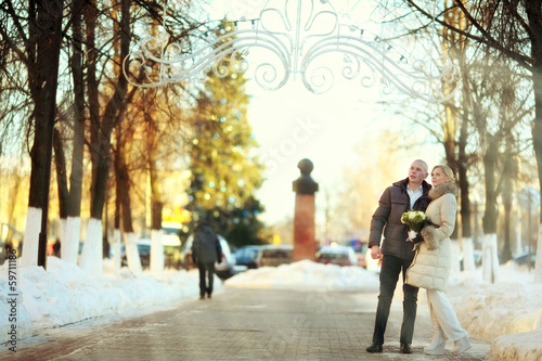 man and woman walking on the street in winter wedding