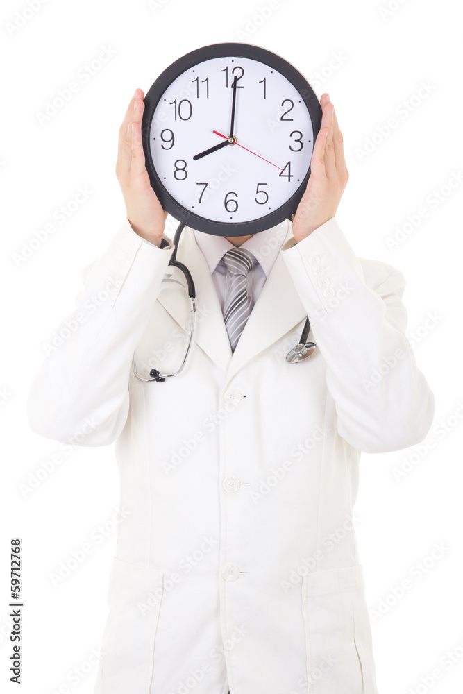 male doctor holding clock in front of face isolated on white male doctor holding clock in front of face isolated on white