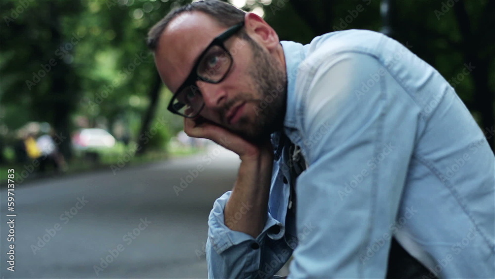 sad man sitting on a bench in a park sad man sitting on a bench in a park