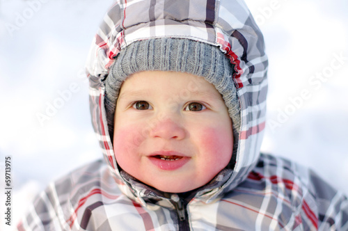 happy baby with rosy cheeks in winter