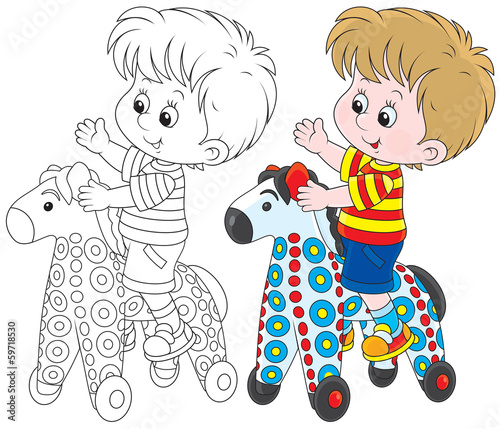 Boy riding on a colorful toy horse