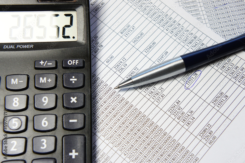 Office table with calculator, pen and accounting document Office table with calculator, pen and accounting document