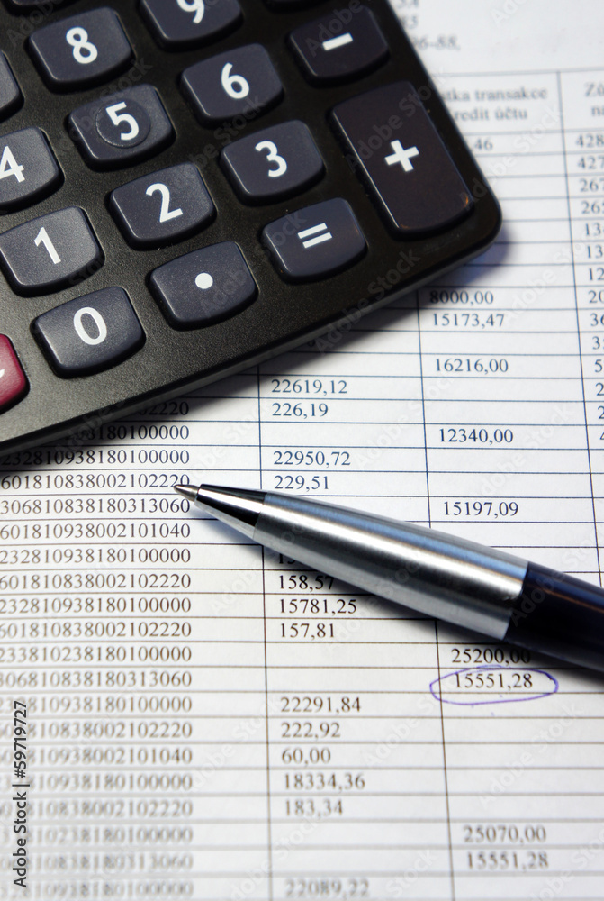 Office table with calculator, pen and accounting document Office table with calculator, pen and accounting document