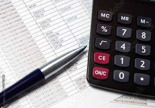 Office table with calculator, pen and accounting document