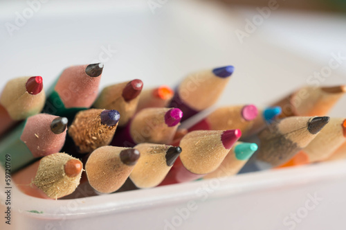 Group of the color pencils lying in a basket close up