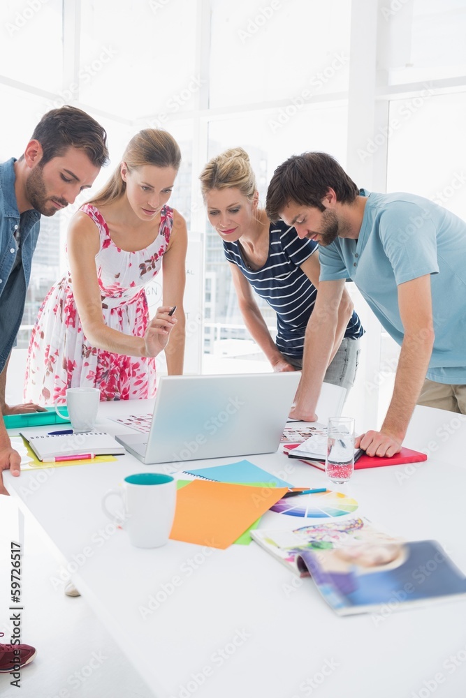 Casual business people using laptop together Casual business people using laptop together