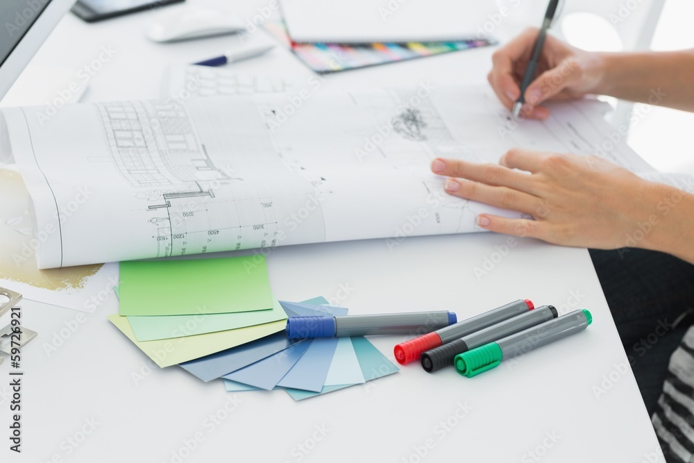Artist drawing something on paper with pen at office Artist drawing something on paper with pen at office