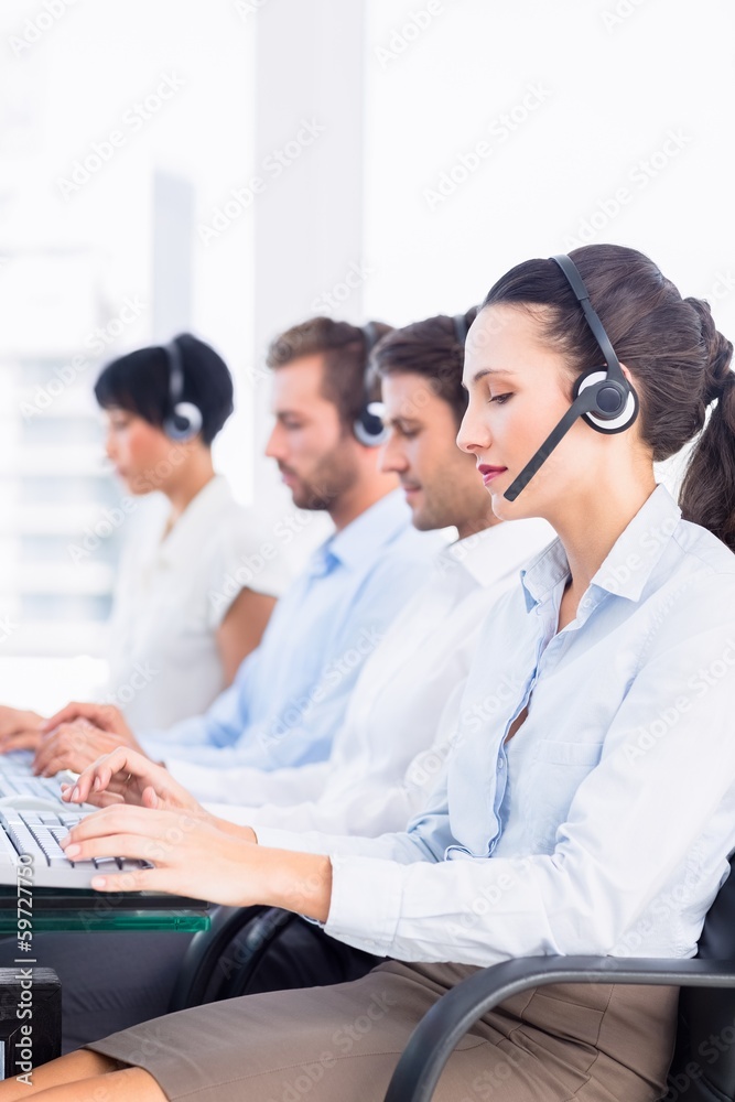 Business colleagues with headsets in a row Business colleagues with headsets in a row