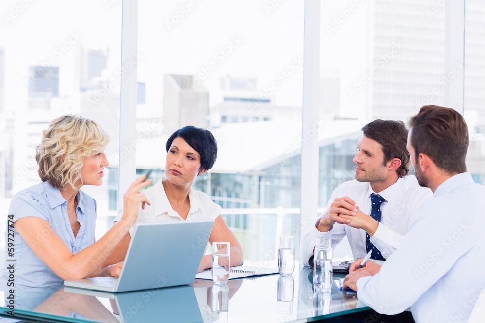 Fototapeta premium Executives sitting around conference table