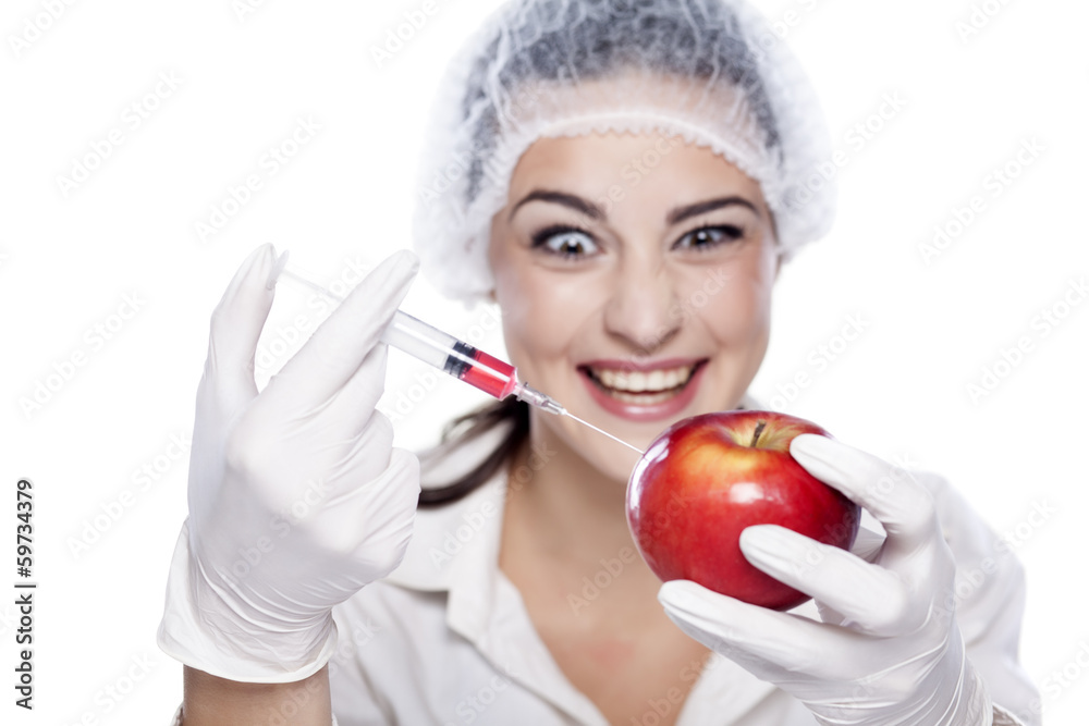 smiling malicious chemist woman injected some liquid in apple