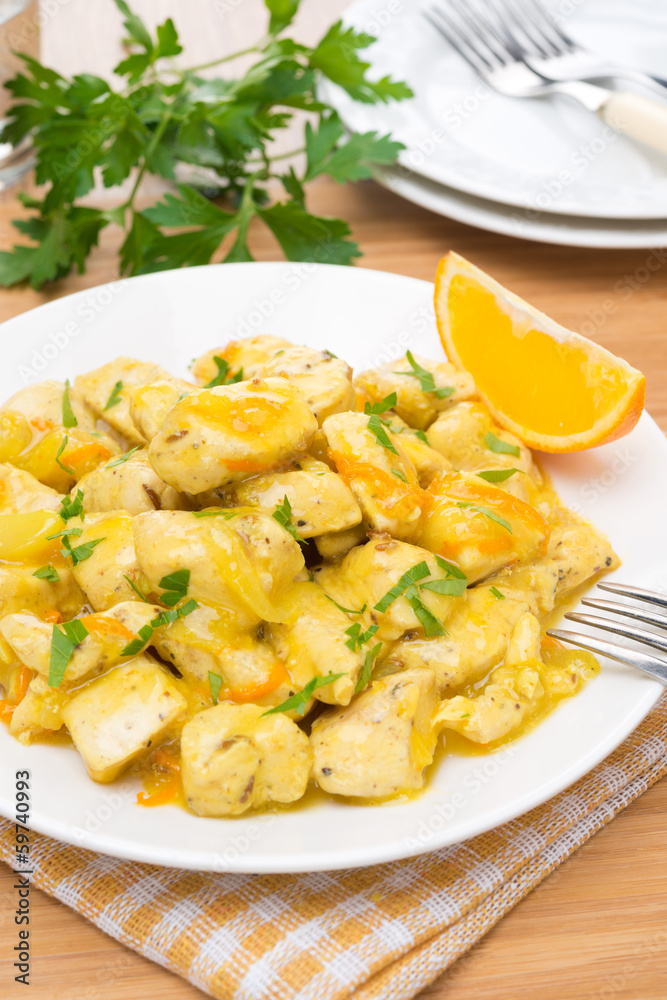 chicken fillet with orange sauce on a plate, vertical chicken fillet with orange sauce on a plate, vertical