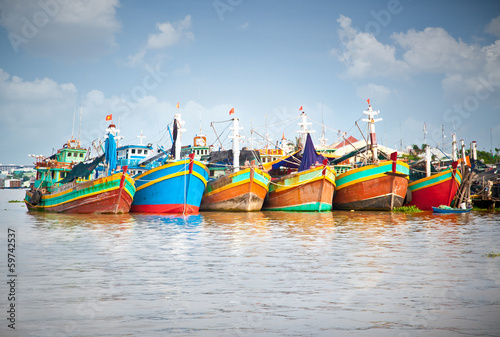 Colorful fishing boats berthed at the port in the Mekong Delta,