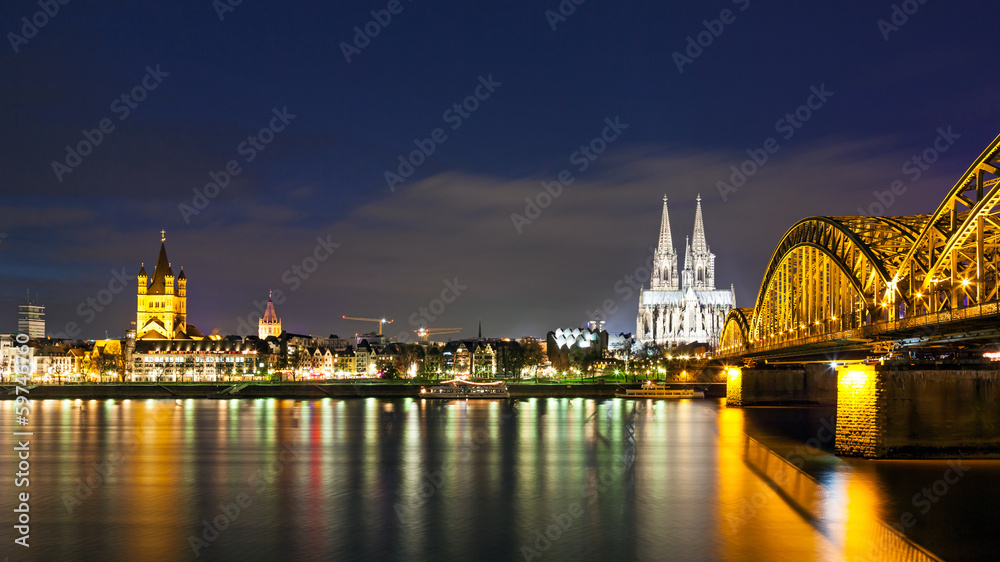 Cologne Cathedral with the Hohenzollern bridge at night