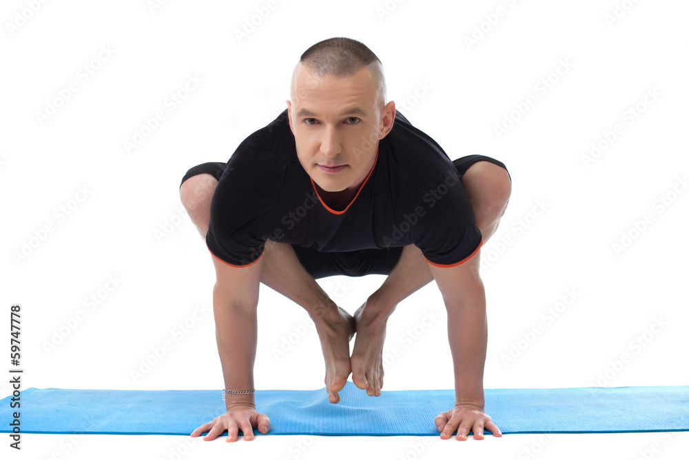 Handsome middle aged man doing yoga in studio Handsome middle aged man doing yoga in studio