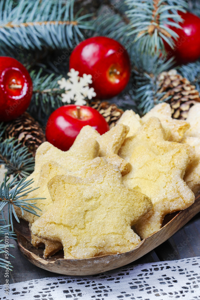 Christmas cookies in star shape, red apples and green fir Christmas cookies in star shape, red apples and green fir