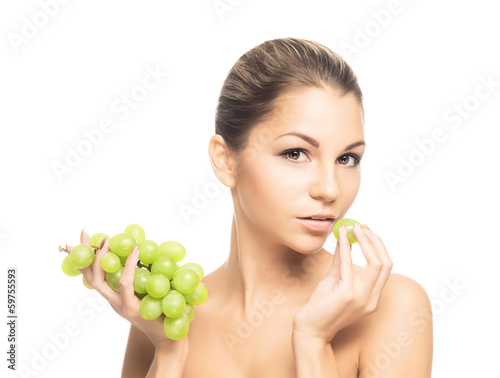 Portrait of a giirl eating grapes isolated on white