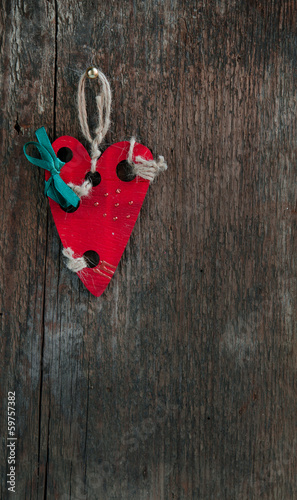 Red wooden heart on old vintage board
