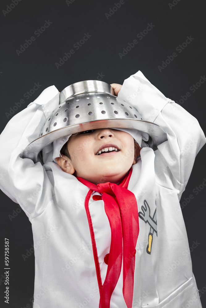 Cuisine, little boy preparing healthy food on kitchen over grey Cuisine, little boy preparing healthy food on kitchen over grey